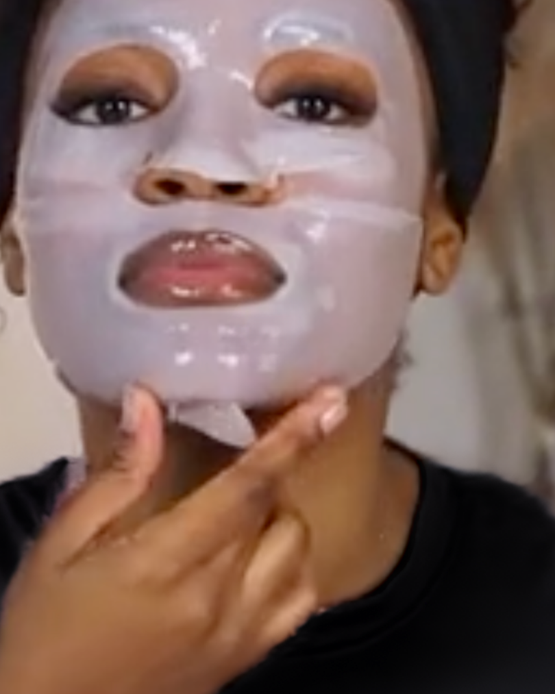 Woman with melanin-rich skin wearing a VOUEE face mask for lifting and firming