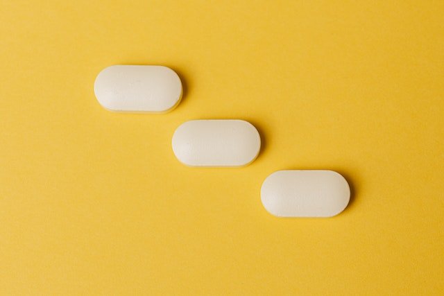 Radiant Skin for melanin-rich skin - three supplement tablets on a yellow background