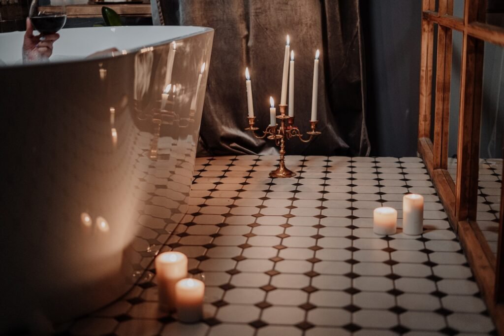 Lighted Candles on Table Near Glass Cup to demonstrate Unlocking the Power of Self-Love: Your Essential Skincare Routine